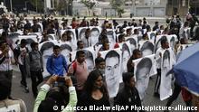 Normal college students join family members of 43 missing students from the Rural Normal School of Ayotzinapa in a march marking the sixth anniversary of the 43 students' enforced disappearance, in Mexico City, Saturday, Sept. 26, 2020. (AP Photo/Rebecca Blackwell) |