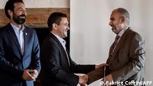 Head of the Houthi prisoner exchange committee Abdulkader al-Murtada (C) shakes hands with Head of the Yemeni government delegation Hadi Haig (R) between ICRC Director for the Near and Middle East Fabrizio Carboni (L) and UN Special Envoy for Yemen Martin Griffiths at the end of a week-long meeting on a Yemen prisoner exchange agreement on September 27, 2020 in Glion, western Switzerland. - Both sides in Yemen's war have agreed to exchange more than 1,000 prisoners, the UN mediator during a week of talks in Switzerland said on September 27, 2020. (Photo by Fabrice COFFRINI / AFP)