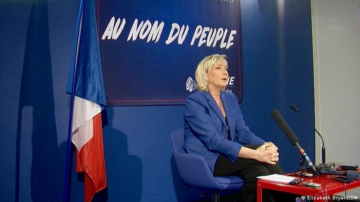 French opposition leader Marine Le Pen sitting in a press conference