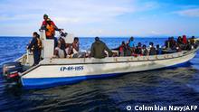 Handout picture released by the Colombian Navy of its members rescuing Haitian migrants stranded off the coast of Acandi, Choco department, Colombia, on September 29, 2020. - Around 100 Haitian migrants were rescued off from a drifting boat off Colombia's Caribbean coast on Tuesday as they tried to reach Panama, Bogota's coastguard service said. (Photo by - / COLOMBIA'S NAVY / AFP) / RESTRICTED TO EDITORIAL USE - MANDATORY CREDIT AFP PHOTO / COLOMBIAN NAVY - NO MARKETING NO ADVERTISING CAMPAIGNS -DISTRIBUTED AS A SERVICE TO CLIENTS
