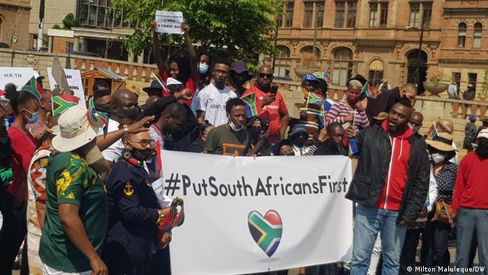 Protesters hold a #PutSouthAfricansFirst banner in Johannesburg