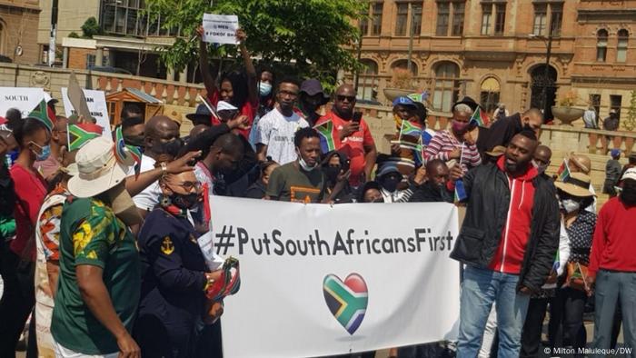 Protesters hold a #PutSouthAfricansFirst banner in Johannesburg