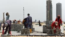 TO GO WITH AFP STORY BY CELIA LEBUR
Workers lay interlocking tiles to build a road in Eko Atlantic City, Lagos, on November 22, 2016.
With frozen cranes, deserted construction sites and empty buildings, Lagos is suffering a hangover from a construction binge as Nigeria wrestles to overcome a damaging recession. On Eko Atlantic, billed as the largest real estate project in Africa, frenetic construction has slowed to a snail's pace. Dubbed the Dubai of Africa, the so-called city within a city is being built over 10 square kilometres (3.9 square miles) on tonnes of sand dredged from the Atlantic Ocean off the coast. / AFP / PIUS UTOMI EKPEI (Photo credit should read PIUS UTOMI EKPEI/AFP via Getty Images)