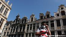 FILE PHOTO: A man wearing a protective mask, that became mandatory in Brussels' public places, walks at the Grand Place, amid the coronavirus disease (COVID-19) outbreak, in Brussels, Belgium September 15, 2020. REUTERS/Yves Herman/File Photo