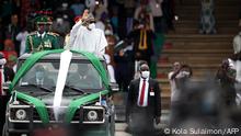 Nigeria’s President Muhammadu Buhari (2nd L) wave at the crowd as he attends a parade during the country’s 60th Independence Celebration at the Eagles Square in Abuja, Nigeria on October 1, 2020. - Nigeria is holding scaled-down celebrations due to the coronavirus pandemic to commemorate six decades since it gained self-rule from Britain in 1960. (Photo by Kola Sulaimon / AFP)