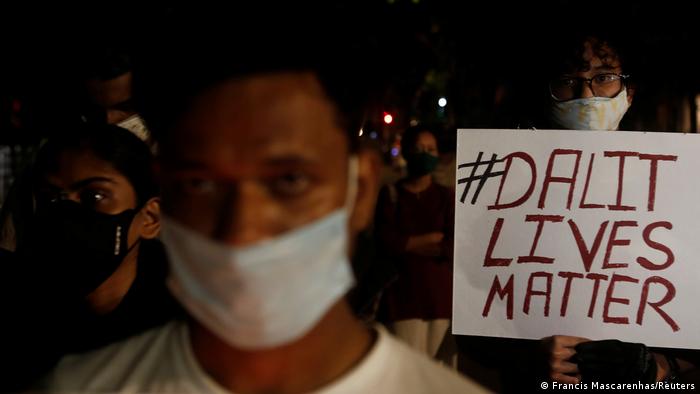 A man holds a placard during a protest after the death of a rape victim, on a street in Mumbai, India