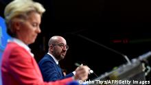 European Council President Charles Michel (R) is watched by European Commission President Ursula von der Leyen as he addresses media on the second day of a European Union (EU) summit at The European Council Building in Brussels on October 2, 2020. (Photo by JOHN THYS / various sources / AFP) (Photo by JOHN THYS/AFP via Getty Images)