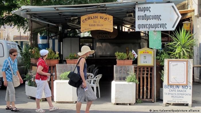 People walking past kebab shop called Berlin Wall in Nicosia, Cyprus