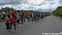 Honduran migrants, part of a caravan heading to the US, walk in Entre Rios, Guatemala, after crossing the border from Honduras, on October 1, 2020. - A new caravan, of at least 5,000 people, left San Pedro Sula on Wednesday midnight in search of the American dream amid the new coronavirus pandemic, which has left over 2,300 dead in Honduras so far. (Photo by Johan ORDONEZ / AFP)