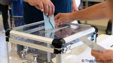 A person casts his vote at a polling station in the referendum on independence on the French South Pacific territory of New Caledonia in Noumea on October 4, 2020. - The French South Pacific territory of New Caledonia votes in an independence referendum on October 4, 2020, which is expected to reject breaking away from France after almost 170 years despite rising support for the move. (Photo by Theo Rouby / AFP)