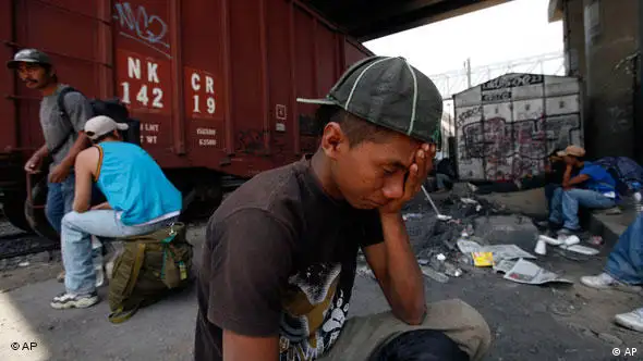 A man who identified himself as Jorge, from Honduras, waits with others to jump on a train that will take him to the Mexico-US border on the outskirts of Mexico City, Wednesday, April 28, 2010. Amnesty International called the abuse of migrants in Mexico a major human rights crisis Wednesday, and accused some Mexican officials of turning a blind eye or even participating in kidnapping, rapes and murders of migrants.(AP Photo/Marco Ugarte)