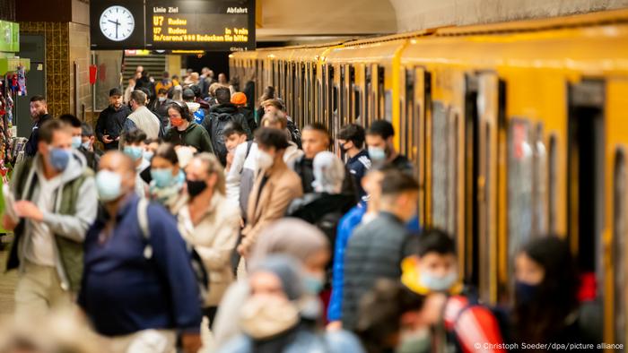 Passengers disembarking and boarding a crowded subway train in Berlin