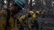 Firefighters walk through burned forest in the US Firefighters walk through burned forest in the US