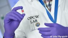 A laboratory technician controls a test vial at the OPCW (The Organisation for the Prohibition of Chemical Weapons) headquarters in the Hague, The Netherlands, on April 20, 2017. - Tucked away in a small industrial zone in the Dutch suburb of Rijswijk, the two-storey building, with about 20 staff, has been key to the two decades of painstaking work by the Organisation for the Prohibition of Chemical Weapons (OPCW) to eliminate the world's toxic arms stockpiles. (Photo by JOHN THYS / AFP)