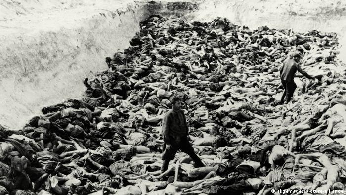 Concentration camp doctor Fritz Klein, who performed experiments on prisoners at Bergen-Belsen, is standing in a large pit of corpses.