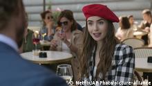This image released by Netflix shows Lily Collins in a scene from the series Emily in Paris, premiering on Friday. (Netflix via AP)