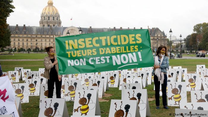Activists protest a government proposal to lift a ban on neonicotinoids, a pesticide blamed for harming bees, to protect sugar beet crops that have been ravaged by insects this year, in front the Invalides in Paris, France, September 23, 2020.