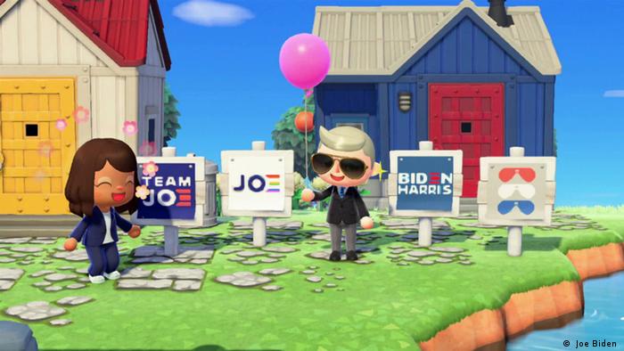 Screenshot des Spiels Animal Crossing: New Horizons: Eine Frau und ein Mann vor Häusern, in deren Vorgärten Biden/Harris-Wahlwerbung zu sehen ist