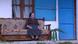 An older woman sits on her porch An older woman sits on her porch