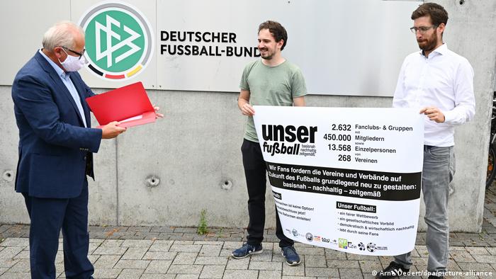 The Unser Fussball (Our Football) petition is presented to the DFB's Fritz Keller
