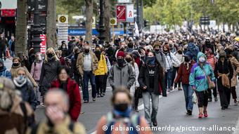 Люди в масках на улице Берлина