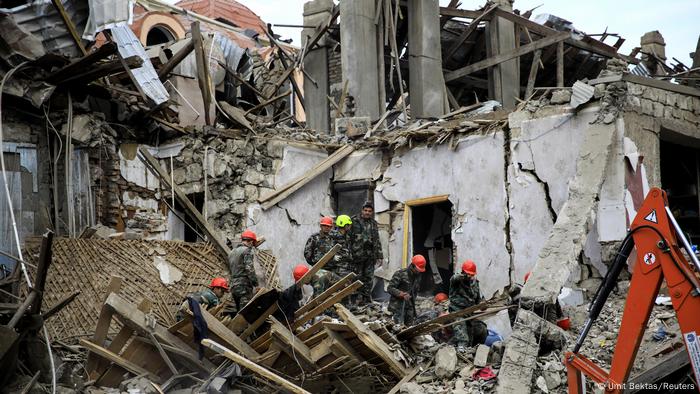 Buildings left in ruins by rocket strike (Umit Bektas/Reuters)