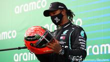 Formula One F1 - Eifel Grand Prix - Nurburgring, Nurburg, Germany - October 11, 2020 Mercedes' Lewis Hamilton celebrates with a red helmet after winning the race Pool via REUTERS/Bryn Lennon