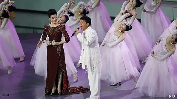 Hong Kong star Jackie Chan, right, and Chinese singer Song Zhuying perform during the opening ceremony at the World Expo site Friday April 30, 2010 in Shanghai, China. (AP Photo/Eugene Hoshiko)
