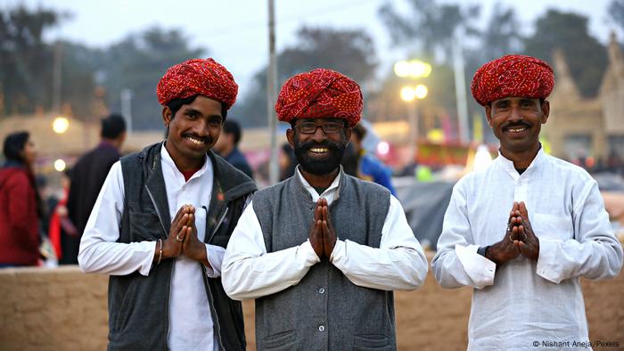 Indian men making the namaste greeting with hands in front of their hearts (Nishant Aneja/Pexels)