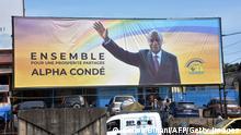 A campaign billboard of the Guinea President presidential candidate for the October elections candidate, Alpha Conde, is seen diplayed in street in Conakry on September 29, 2020. (Photo by CELLOU BINANI / AFP) (Photo by CELLOU BINANI/AFP via Getty Images)