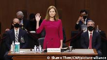 Supreme Court nominee Judge Amy Coney Barrett stands as she is sworn in during her confirmation hearing before the Senate Judiciary Committee on Capitol Hill in Washington, DC, USA, 12 October 2020. Credit: Shawn Thew / Pool via CNP
