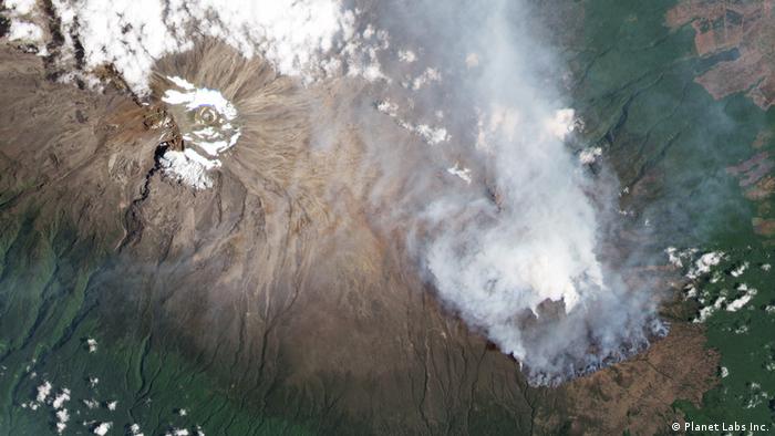 A satellite image shows smoke surrounding Mount Kilimanjaro
