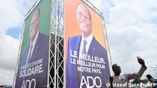 October 16, 2020***
A man takes a selfie next to Ivorian President Alassane Ouattara's campaign poster in Abobo, a suburb of Abidjan, on October 16, 2020, ahead of the country's presidential election to be held on October 31, 2020. (Photo by Issouf SANOGO / AFP)