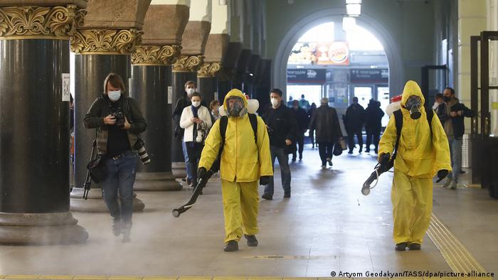Сотрудники МЧС РФ в защитных костюмах дезинфицируют помещение Ярославского вокзала в Москве