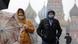 Man and woman in masks on Moscow's Red Square Man and woman in masks on Moscow's Red Square