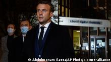 French President Emmanuel Macron, flanked by French Interior Minister Gerald Darmanin, second left, speaks in front of a high school Friday Oct.16, 2020 in Conflans Sainte-Honorine, northwest of Paris, after a history teacher who opened a discussion with high school students on caricatures of Islam's Prophet Muhammad was beheaded. French President Emmanuel Macron denounced what he called an Islamist terrorist attack against a history teacher decapitated in a Paris suburb Friday, urging the nation to stand united against extremism. (Abdulmonam Eassa, Pool via AP)