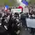 People gather on Republique Square with posters reading "No to barbarity" and "I'm a. teacher" for a demonstration Sunday Oct. 18, 2020 in Paris.