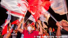 Supporters of right-wing Turkish nationalist Ersin Tatar celebrate his win in the presidential election in the northern part of Nicosia, the capital of the self-proclaimed Turkish Republic of Northern Cyprus (TRNC) on October 18, 2020. - Turkish-held northern Cyprus, a breakaway state recognised only by Ankara, voted in a run-off election held amid heightened tensions in the eastern Mediterranean, with early results indicating a tight race. The presidential vote pitted incumbent Mustafa Akinci, 72 -- who supports reunification with the majority Greek-speaking Republic of Cyprus in the south -- against the right-wing Turkish nationalist Ersin Tatar. (Photo by Birol BEBEK / AFP) (Photo by BIROL BEBEK/AFP via Getty Images)