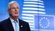 Michel Barnier stands in front of a blue screen with the EU flag on it Michel Barnier stands in front of a blue screen with the EU flag on it