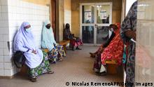Women wait to be cared for by a doctor or nurse in the waiting room of the Ossaka Gazoby Central Maternity Hospital in Niamey on May 8, 2020. - The Niger health authorities on May 7, 2020 launched an appeal to the population of Niamey to go back to the health centres, which are less frequented since the arrival of the COVID019 coronavirus in Niger and the fear of being contaminated. (Photo by Nicolas Réméné / AFP) (Photo by NICOLAS REMENE/AFP via Getty Images)