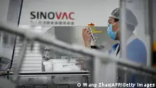24.09.2020 *** A staff member works during a media tour of a new factory built to produce a COVID-19 coronavirus vaccine at Sinovac, one of 11 Chinese companies approved to carry out clinical trials of potential coronavirus vaccines, in Beijing on September 24, 2020. (Photo by WANG ZHAO / AFP) (Photo by WANG ZHAO/AFP via Getty Images)