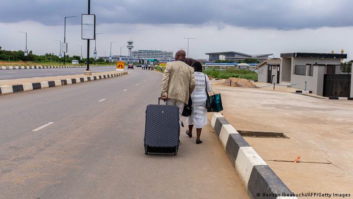 A couple make their way to the termainal at Ikeja Airport in Lagos, Nigeria