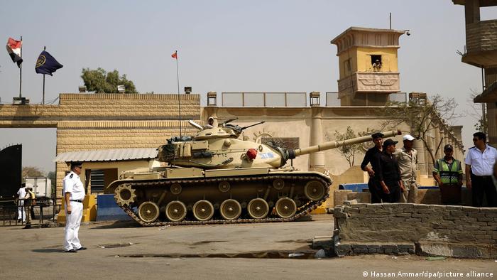 Egyptian security forces stand guard outside one of the entrances of Tora prison, in Cairo