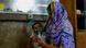 Woman holding a nebulizer on the face of her baby in Bangladesh Woman holding a nebulizer on the face of her baby in Bangladesh