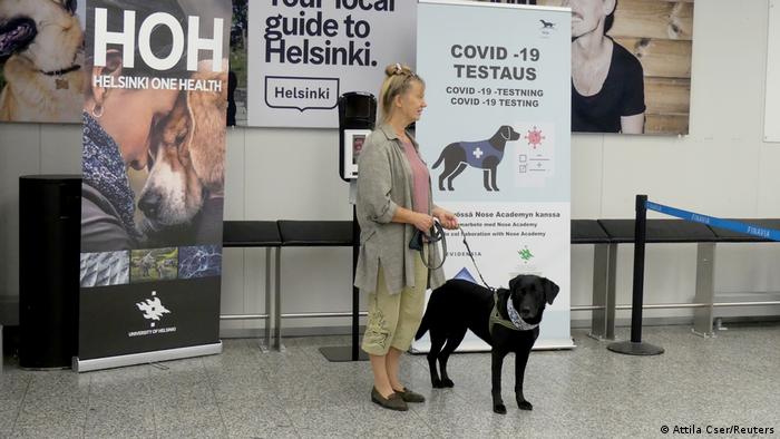 Miina with handler at Helsinki airport (Attila Cser/Reuters)