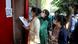 Students wearing face masks are checking for their enrollment numbers at an examination center in New Delhi Students wearing face masks are checking for their enrollment numbers at an examination center in New Delhi