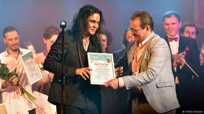 Student Mehran Mirmiri at the O-Fest Festival in Ukraine being handed an award