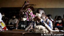 2.6.2020, Bamako, Mali, A Malian pupil wears a face mask in the classroom of a school as the government decided to resume lessons after two months of closure due to the spread of COVID-19 coronavirus, in Bamako on June 2, 2020. - All the students have been provided with masks to wear mandatorily and the lessons have been reorganised in order to have a maximum number of 25 students per classroom. (Photo by MICHELE CATTANI / AFP)