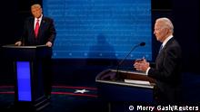Democratic presidential candidate former Vice President Joe Biden answers a question as U.S. President Donald Trump listens during the second and final presidential debate at the Curb Event Center at Belmont University in Nashville, Tennessee, U.S., October 22, 2020. Morry Gash/Pool via REUTERS
