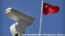 A Chinese flag flies near a Hikvision security camera monitoring a traffic intersection in Beijing, Tuesday, Oct. 8, 2019. The United States is blacklisting a group of Chinese tech companies that develop facial recognition and other artificial intelligence technology that the U.S. says is being used to repress China's Muslim minority groups. (AP Photo/Mark Schiefelbein) |